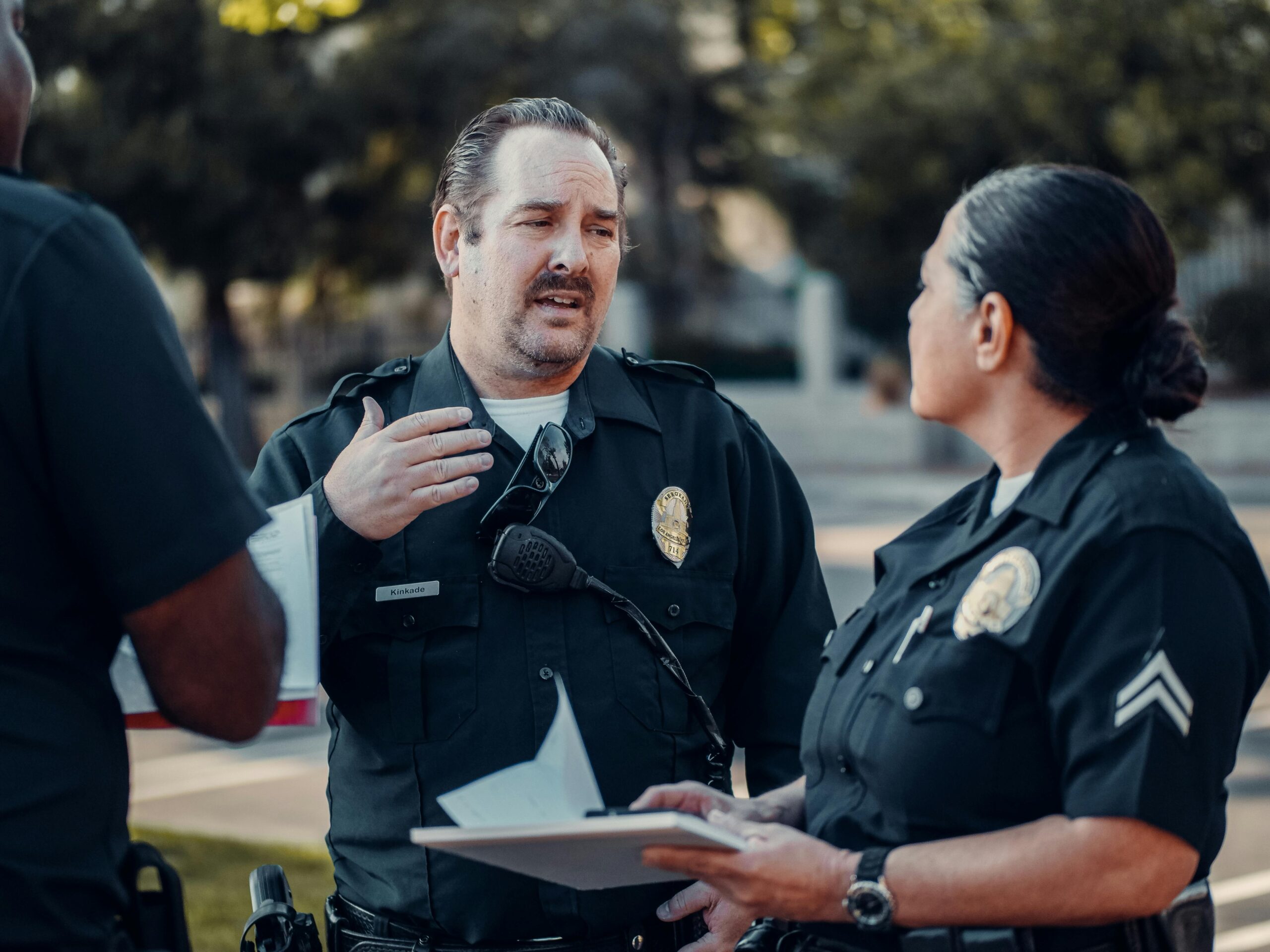 Male and female police officer talking outside