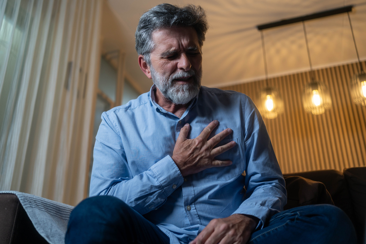 Older man grabbing his chest in pain